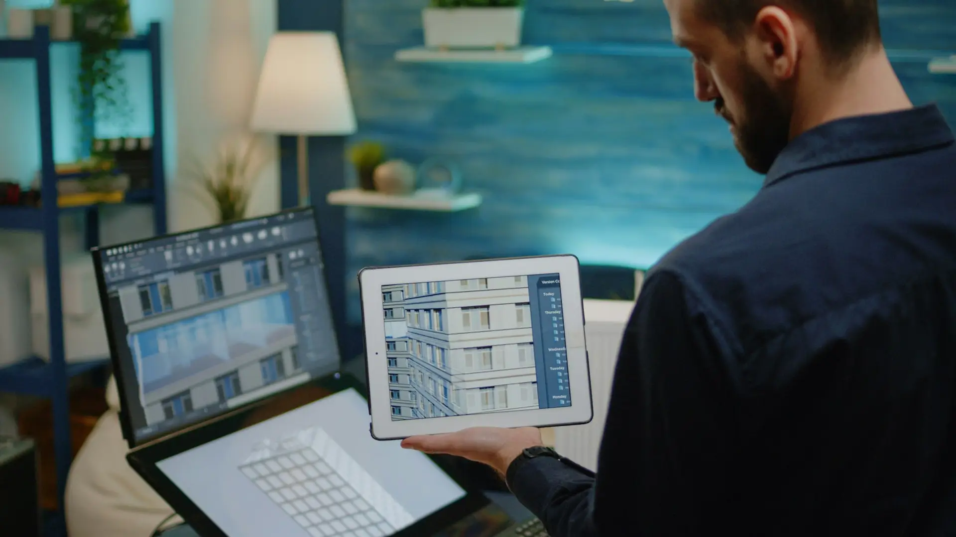architect holding digital tablet with building model